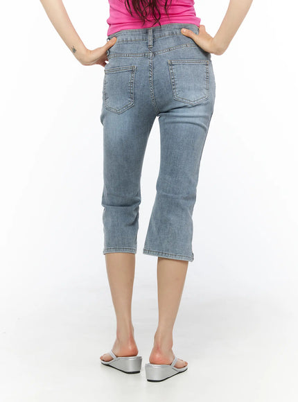Aris High-Waist Capri Jeans CU530 Light blue back view on model showing dual patch pockets and faded wash denim texture, silver sandals