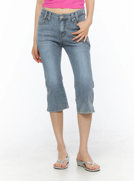 LEWKIN Aris High-Waist Capri Jeans CU530 Light blue front view on model wearing pink top and silver wedge sandals, washed denim capri fit