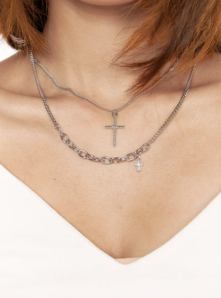 Arlo Cross Necklace IL522 Silver front close-up on model layered with chunky oval link chain both featuring cross pendants worn with white top