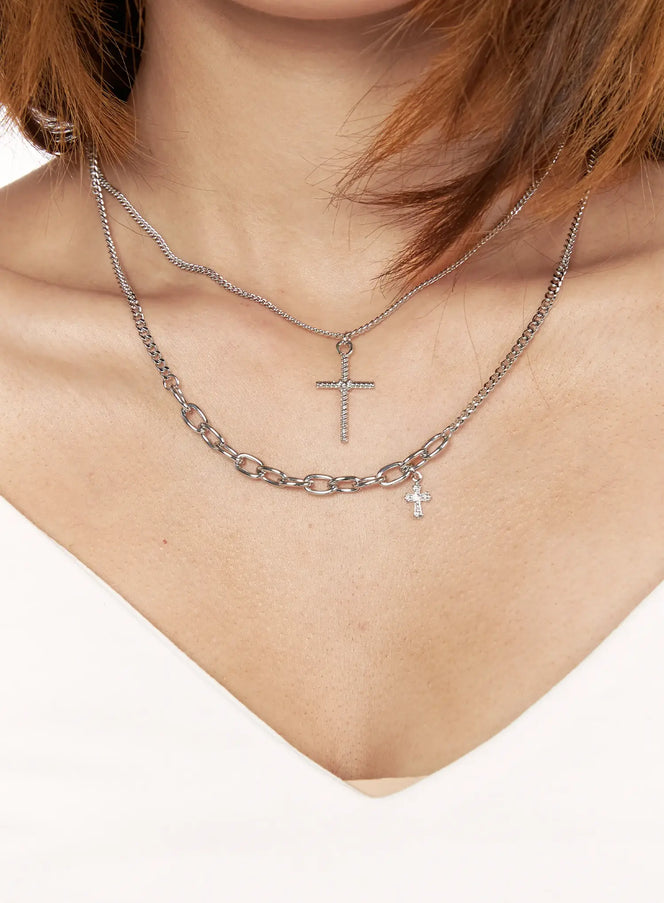 Arlo Cross Necklace IL522 Silver front close-up on model layered with chunky oval link chain both featuring cross pendants worn with white top