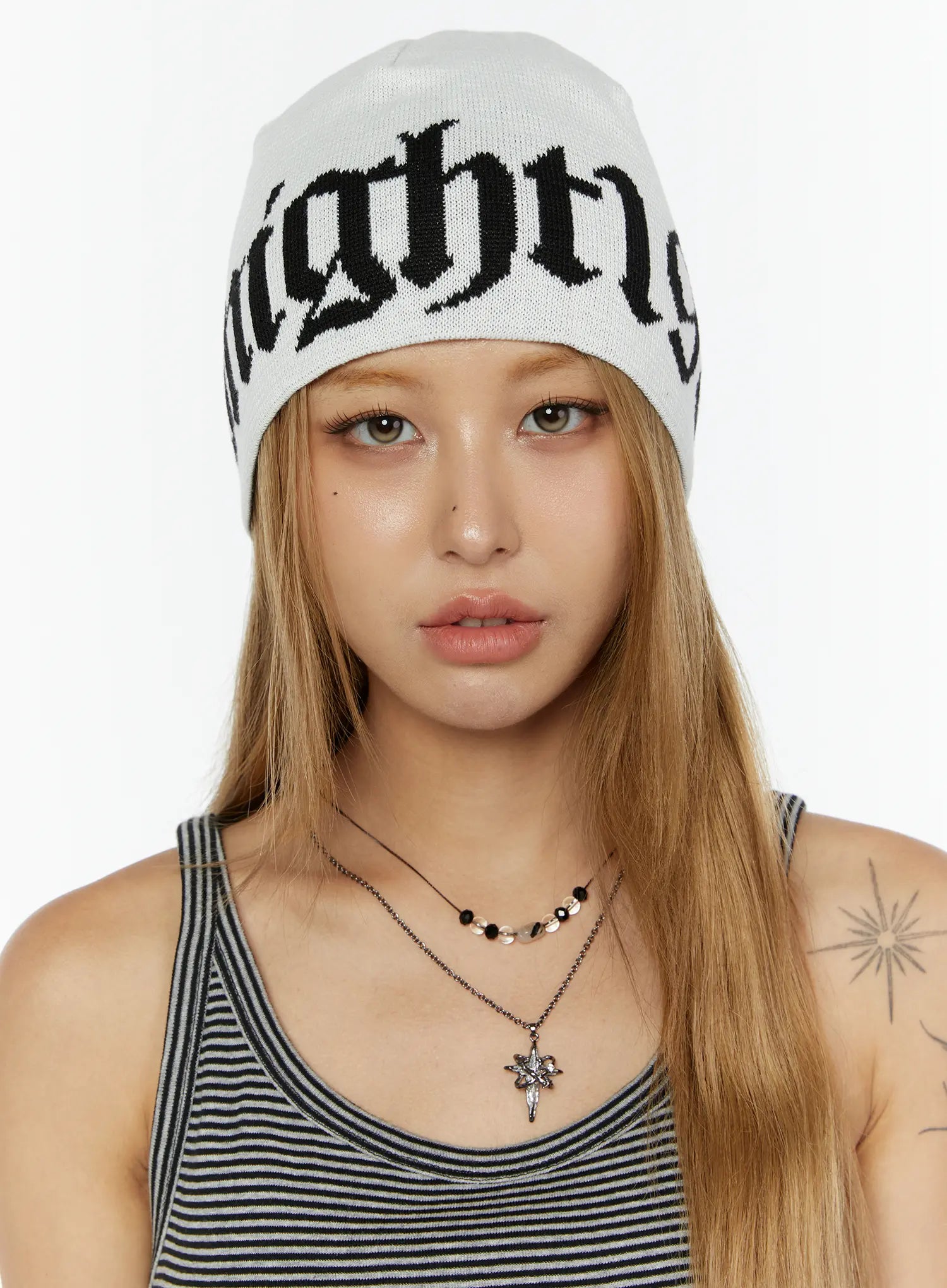 LEWKIN Aspen 1988 beanie IL503 White front close-up on model facing camera wearing knit beanie with black gothic letter jacquard