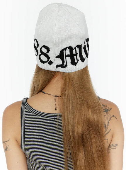 Aspen 1988 beanie IL503 White back view on model showing rear gothic script lettering and knit texture of white beanie