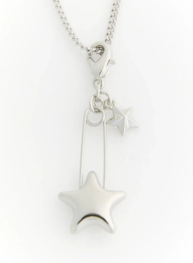 Astra Star Pin Necklace IL522 Silver detail close-up showing puffed star charm safety pin pendant and small star on curb chain