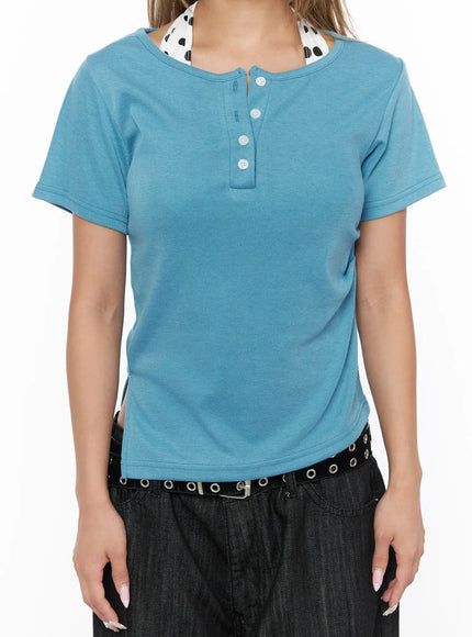 Asymmetric Button Short Sleeve Top CU524 Blue close-up front torso shot highlighting henley button placket and polka dot inner collar layered neckline detail