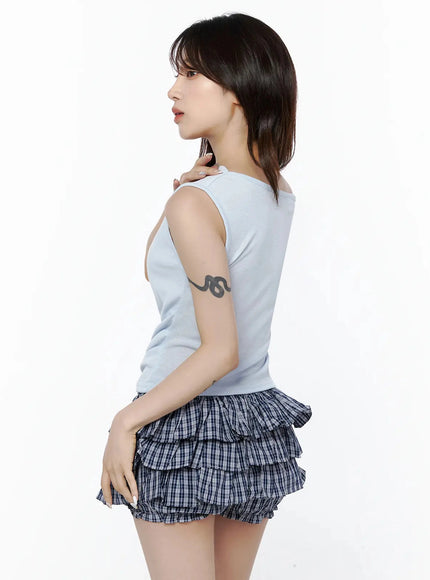 Asymmetric Off-Shoulder Top IL506 Light blue side back model shot showing slim silhouette with arm raised hand on shoulder highlighting fabric drape