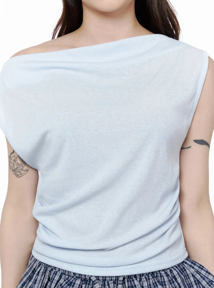 Asymmetric Off-Shoulder Top IL506 Light blue close-up front detail shot on model showing asymmetric draped neckline and soft lightweight knit texture