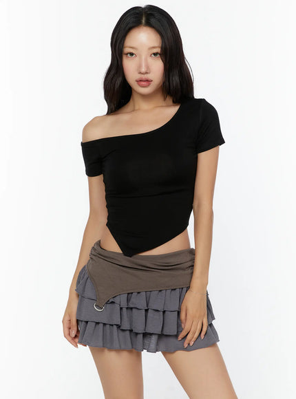 Asymmetric One-Shoulder Top CU529 Black front shot on model standing straight, one-shoulder off-shoulder ribbed crop top paired with tiered ruffle skirt