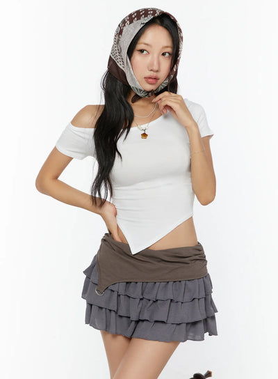LEWKIN Asymmetric One-Shoulder Top CU529 White S/M front shot on model with scarf headwrap, asymmetric hem crop top styled with layered ruffle mini skirt