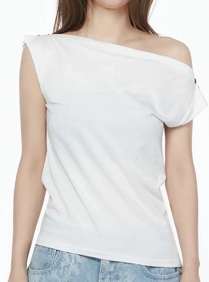 Asymmetric One-Shoulder Top IU525 White close-up front torso shot on model highlighting off-shoulder neckline and metal button detail on shoulder