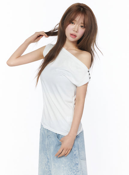 Asymmetric One-Shoulder Top IU525 White three-quarter side shot on model holding hair showing button shoulder detail and body-skimming silhouette