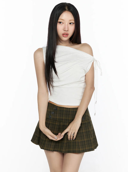 Asymmetric Shirred Off-Shoulder Top CL524 white front shot on model standing straight, one-shoulder ruched crop top with white ribbon tie, paired with green plaid mini skirt