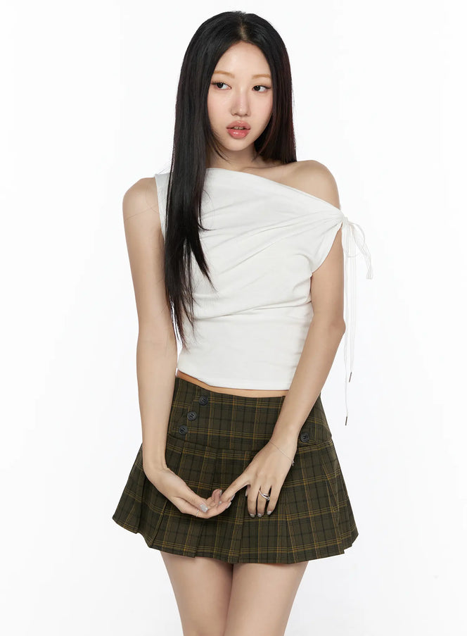 Asymmetric Shirred Off-Shoulder Top CL524 white front shot on model standing straight, one-shoulder ruched crop top with white ribbon tie, paired with green plaid mini skirt