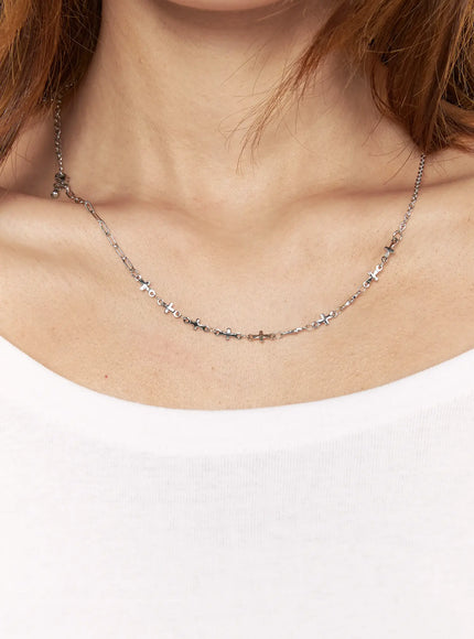 Atlas Cross Necklace IL517 silver on-model front view worn on neck over white top showing full cross-link chain drape at chest