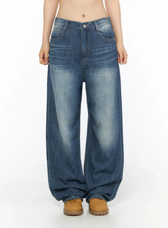LEWKIN Auralie Vintage Washed Wide Leg Jeans CL502 Blue front view on model size S showing washed denim low-rise waist with tan boots