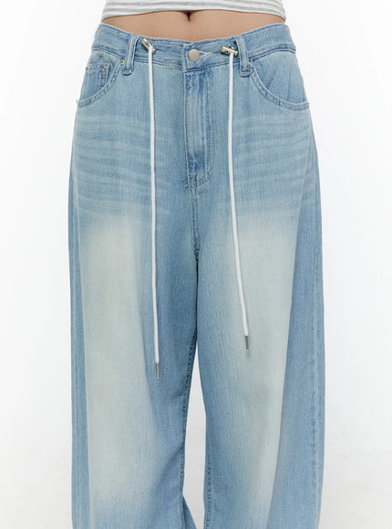 Aurelie Drawstring Washed Wide Leg Jeans CL507 Light blue close-up front detail shot showing white rope drawstring, silver aglets, button fly and faded wash