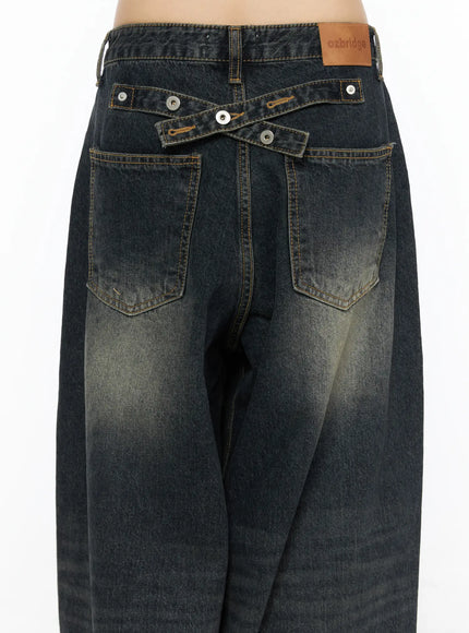 Avie Vintage Wash Wide Leg Jeans CU530 Dark blue close-up back waist detail showing cross-strap hardware back patch pockets leather brand label and gold topstitching