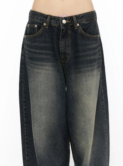 Avie Vintage Wash Wide Leg Jeans CU530 Dark blue close-up front waist detail on model showing button fly front pockets gold stitching and vintage faded texture