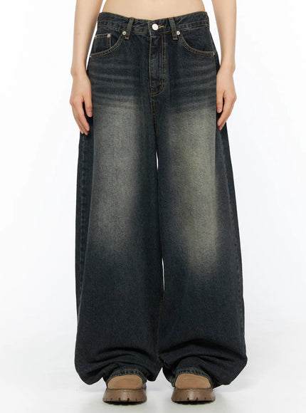 LEWKIN Avie Vintage Wash Wide Leg Jeans CU530 Dark blue front view on model cropped at waist showing wide-leg silhouette faded wash and button fly