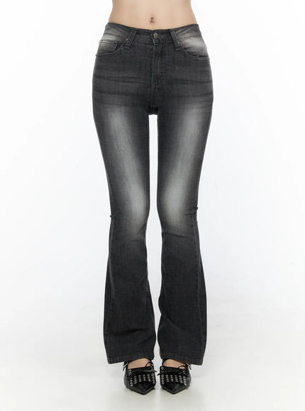 Avielle Classic Bootcut Jeans CL527 Black front view on model, washed black bootcut denim with flared hem, styled with black bow-detail pointed flats