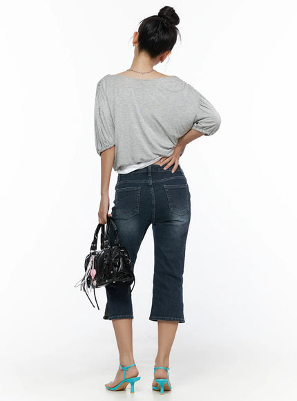 Axel Slit Capri Jeans CL510 dark blue back shot on model with gray top and black bag, showing rear pockets and cropped flared hem