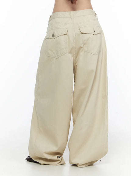 LEWKIN Back Pocket Wide Leg Pants CL524 Beige back view on model showing flap back pockets with button and zip hardware, wide-leg silhouette, cotton fabric