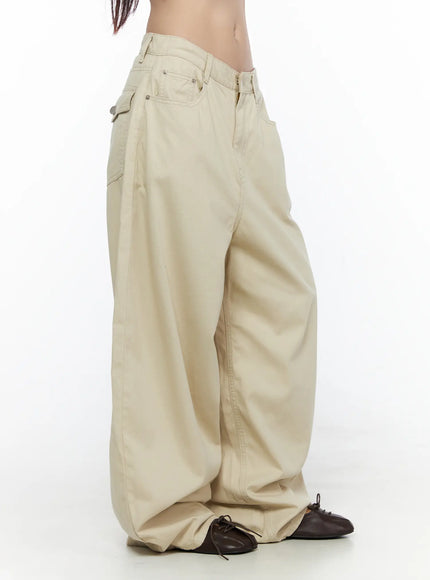 Back Pocket Wide Leg Pants CL524 Beige side view on model showing exaggerated balloon wide-leg silhouette, low-rise waist, and pooling hem