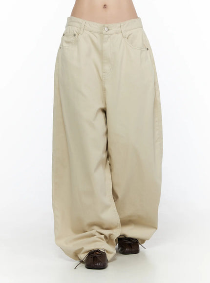 Back Pocket Wide Leg Pants CL524 Beige front view on model showing wide balloon leg silhouette, low-rise fit, five-pocket design, and pooled hem