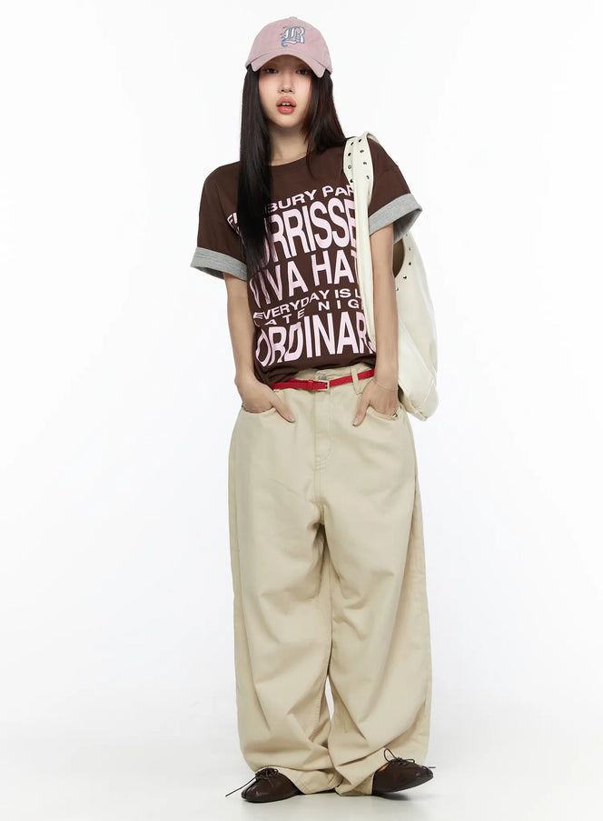 Back Pocket Wide Leg Pants CL524 Beige styled on model full-length front view with graphic tee, red belt, and tote bag, wide-leg fit