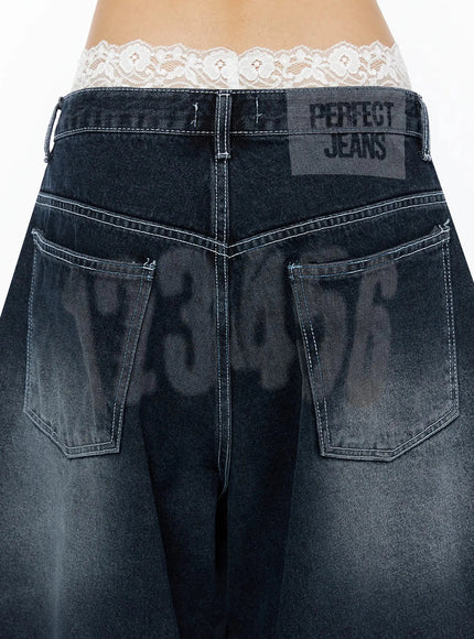 Back Print Jorts IL509 Dark blue close-up detail of back waistband showing PERFECT JEANS label patch and graphic number print on washed denim