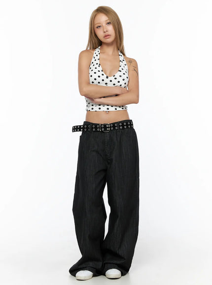 Baddie Polka Dot Halter Top CU524 White full-length front shot on model with arms crossed, black polka dot halter crop top, paired with wide-leg dark denim and belt