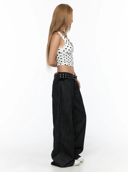 Baddie Polka Dot Halter Top CU524 White side shot on model showing halter neck strap, ruched crop top profile, black polka dot print, with wide-leg dark denim