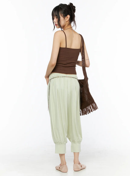 Balloon Joggers CU530 light green back view on model wearing brown cami top and fringe bag, showing gathered elastic waist and relaxed balloon leg