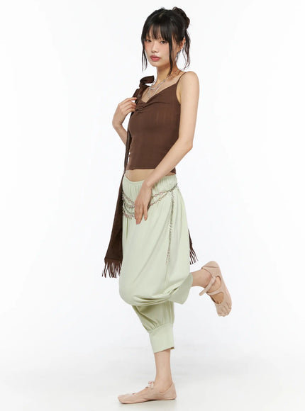 Balloon Joggers CU530 light green side view on model with one leg raised, showing voluminous balloon drop-crotch silhouette and ribbed ankle cuffs