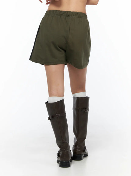 Banded Cotton Shorts CU524 Dark green back shot on model showing clean rear panel, elastic waistband, and black side stripe detail