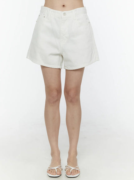 LEWKIN Basic Cotton Shorts IL506 White front view on model, high-waist denim shorts with silver button closure, worn with white strappy sandals, size S