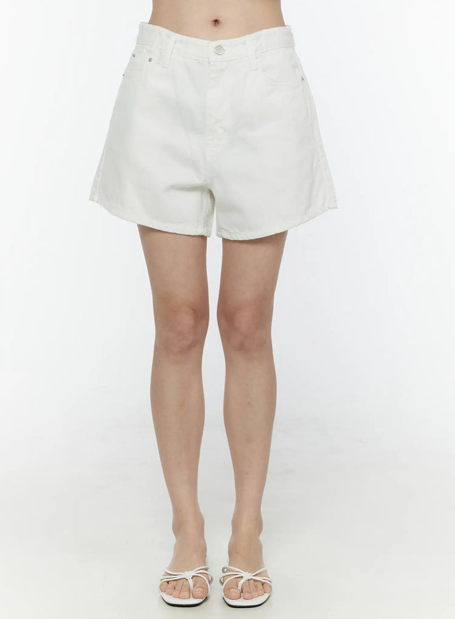 LEWKIN Basic Cotton Shorts IL506 White front view on model, high-waist denim shorts with silver button closure, worn with white strappy sandals, size S