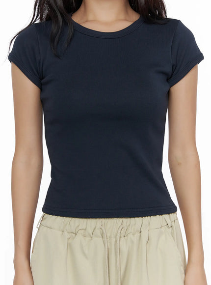 Basic Crewneck Tee CL510 Dark blue close-up detail shot on model highlighting ribbed crewneck collar and fitted cap sleeve with rolled cuff detail