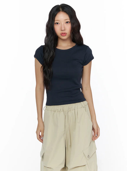 Basic Crewneck Tee CL510 Dark blue front close-up shot on model showing ribbed fabric texture, round neckline, and cropped cap sleeve silhouette
