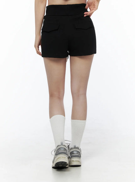 Basic Drawstring Lounge Shorts IU525 Black back close-up on model showing dual flap pockets, high-rise ribbed waistband and sneakers