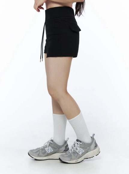 Basic Drawstring Lounge Shorts IU525 Black side shot on model showing cargo-style side pocket detail, drawstring and high-rise silhouette with sneakers