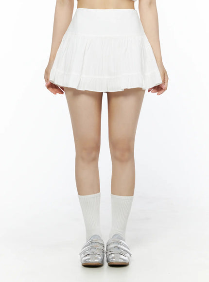 LEWKIN Basic Frill Flare Mini Skirt IU525 White S/M front model shot standing upright showing tiered pleated mini skirt with high waistband paired with white socks and silver shoes