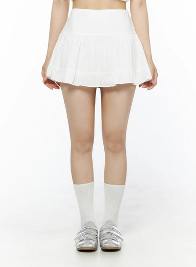 LEWKIN Basic Frill Flare Mini Skirt IU525 White S/M front model shot standing upright showing tiered pleated mini skirt with high waistband paired with white socks and silver shoes