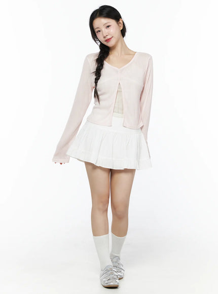 Basic Frill Flare Mini Skirt IU525 White full outfit front model shot smiling styled with open pink knit cardigan lace camisole white socks and silver flats