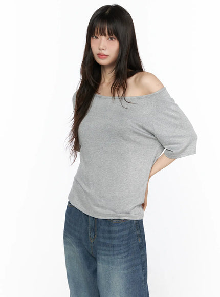 Basic Loose Fit Asymmetric Tee CL522 Gray side shot on model showing off-shoulder neckline and relaxed cotton fabric paired with wide-leg denim