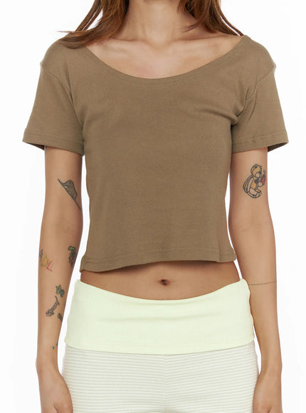 Basic Off-Shoulder Crop Tee CL503 Dark beige close-up front detail shot on model showing wide scoop neckline cotton fabric texture and cropped hem with cream ribbed shorts