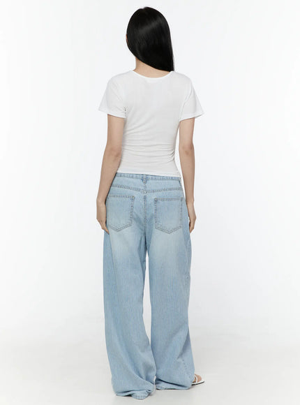 Basic Round Neck Tee IL506 White back model shot showing clean back seam, short sleeves, and fitted body-hugging cut styled with striped wide-leg jeans