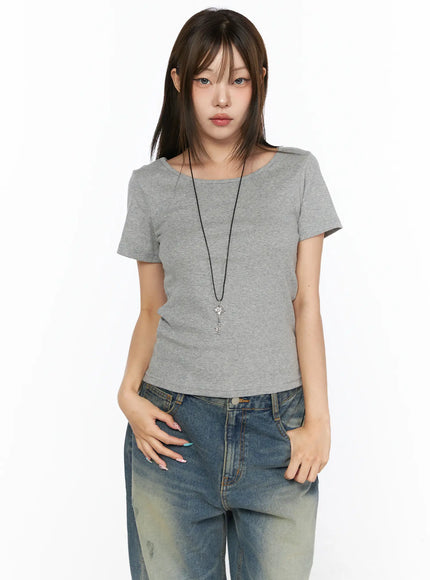 Basic Round Neck Top CL517 gray front view on model styled with wide-leg distressed jeans, key pendant necklace, hands in pockets, slim ribbed knit