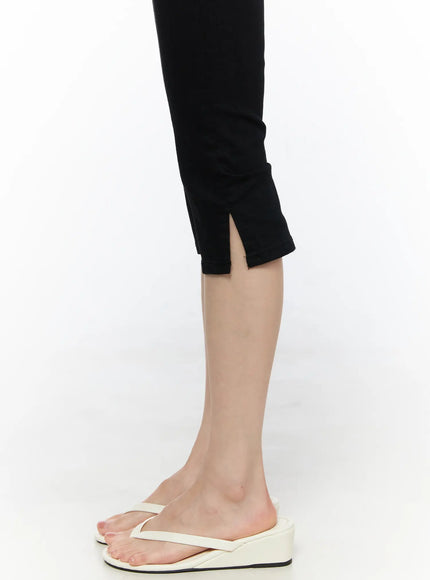 Basic Slit Cotton Capri Pants CL522 Black close-up detail shot of side slit hem at calf on model wearing white wedge thong sandals