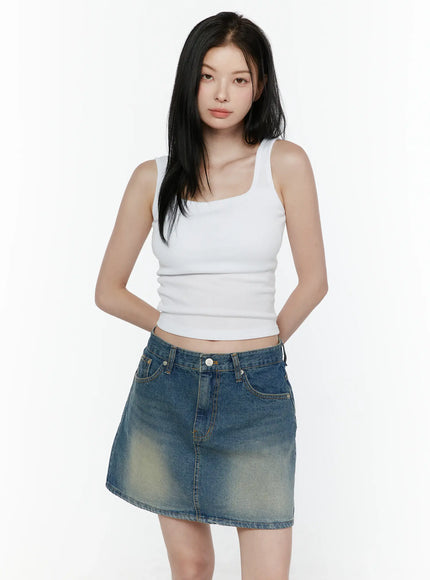 Basic Tank Top IL506 White front shot on model standing upright without accessories showing ribbed crop tank with square neck and denim mini skirt