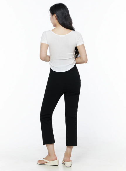 Basic U-Neck Tee IU525 White back shot on model showing rear neckline crop hem and ribbed fabric paired with black trousers and white sandals